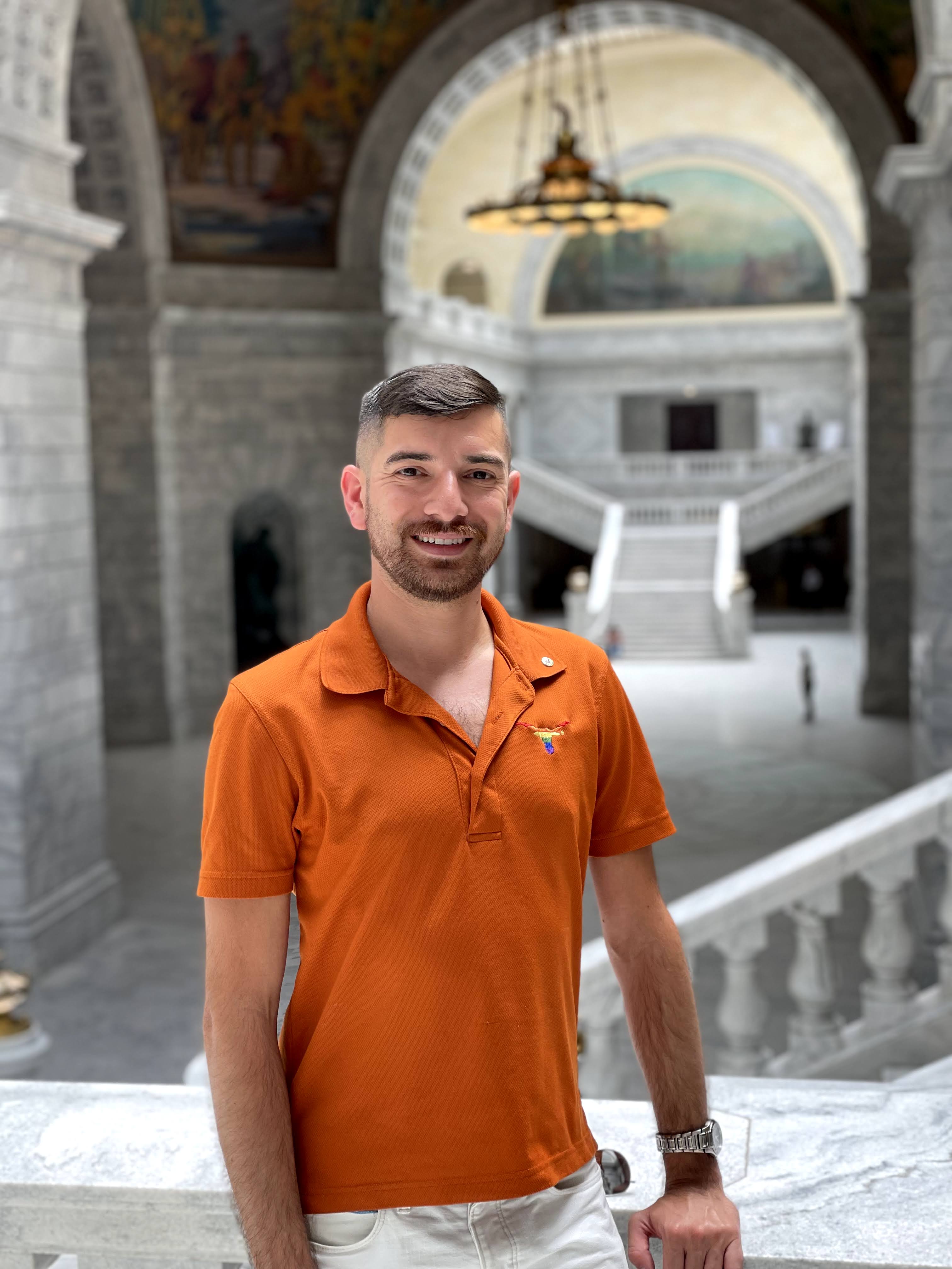 Photo of John Cano in a burnt orange polo