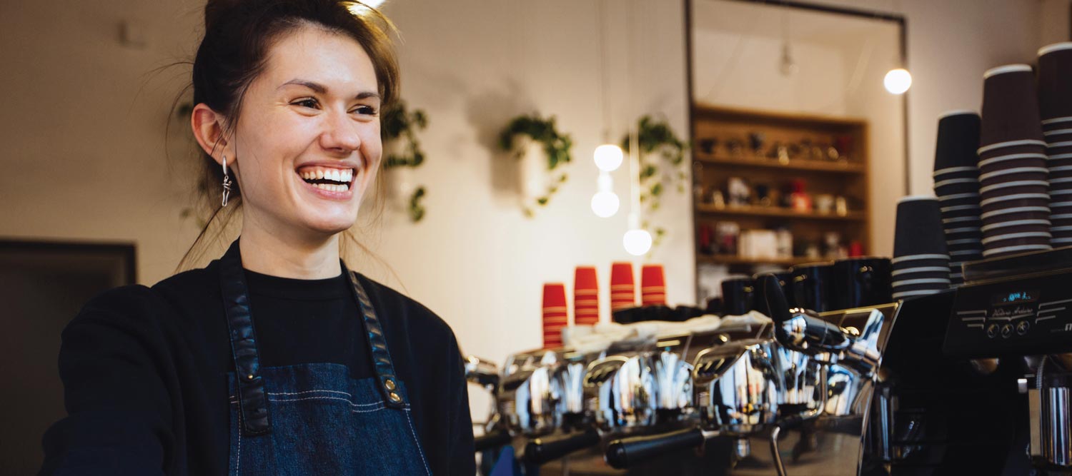Barista Smiling Behind Counter
